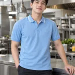 Áo polo đồng phục màu xanh dương nhạt, bo tay đồng màu, form bo cổ sọc, chất cotton rayon